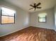 This bedroom boasts wood floors, a ceiling fan, and multiple windows at 170 Lady Susan Ct, Casselberry, FL 32707