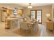 Eat-in kitchen includes a wood dining table with six chairs and views through French doors to the backyard at 170 Lady Susan Ct, Casselberry, FL 32707