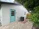 Back exterior with a charming patio, light-blue door, and modern AC unit at 170 Lady Susan Ct, Casselberry, FL 32707