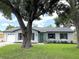 Charming one-story home with a brick exterior, a well-manicured lawn, and a delightful turquoise front door at 170 Lady Susan Ct, Casselberry, FL 32707