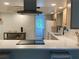 Contemporary kitchen featuring quartz countertops, stainless steel hood, and sleek tile backsplash at 170 Lady Susan Ct, Casselberry, FL 32707