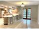 Modern kitchen with tile floors, light cabinets, a breakfast bar, and stainless steel appliances at 170 Lady Susan Ct, Casselberry, FL 32707