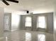 Spacious living room featuring sleek tile flooring, ceiling fans, and bright natural light at 170 Lady Susan Ct, Casselberry, FL 32707