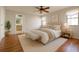 Staged bedroom features hardwood floors, neutral colors, an ensuite bath, and lots of natural light at 170 Lady Susan Ct, Casselberry, FL 32707