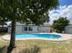 Backyard with a refreshing kidney-shaped pool, brick paver decking, and surrounded by mature trees and lawn at 170 Lady Susan Ct, Casselberry, FL 32707