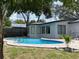 Backyard view of a kidney shaped pool with brick paver decking, set in a verdant yard with mature trees at 170 Lady Susan Ct, Casselberry, FL 32707