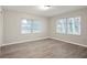 Bright bedroom featuring wood-look flooring and natural light from the windows at 1704 15Th St, Orange City, FL 32763