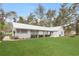Charming single-story home featuring a well-manicured lawn and a screened porch at 1704 15Th St, Orange City, FL 32763