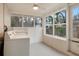 Bright laundry room with large windows, a ceiling fan, and a standard washer and dryer at 1704 15Th St, Orange City, FL 32763