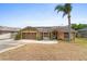 Charming single-story home with a two car garage, solar panels, and a welcoming front patio and lawn at 1969 La Rue Ave, Deltona, FL 32725