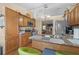 Cozy eat-in kitchen features wood cabinets, granite countertops, stainless appliances, and breakfast bar seating at 1969 La Rue Ave, Deltona, FL 32725