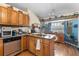 Traditional eat-in kitchen featuring wood cabinets, granite countertops, and a stainless steel dishwasher at 1969 La Rue Ave, Deltona, FL 32725