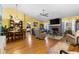 Spacious living room with hardwood floors, a brick fireplace, and an adjacent dining area at 1969 La Rue Ave, Deltona, FL 32725