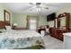 Spacious main bedroom with neutral colored walls, ceiling fan, and a vintage writing desk at 1969 La Rue Ave, Deltona, FL 32725