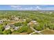Wide aerial shot of homes interspersed among lush trees and verdant landscapes at 245 Country Circle E Dr, Port Orange, FL 32128