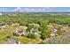 Aerial view showcases home nestled in a lush, green neighborhood with mature trees at 245 Country Circle E Dr, Port Orange, FL 32128