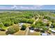Sprawling landscape showing a blue home surrounded by lush greenery and a winding street at 245 Country Circle E Dr, Port Orange, FL 32128