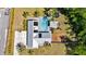 Overhead view showcasing a backyard pool and patio area of a home surrounded by mature trees at 245 Country Circle E Dr, Port Orange, FL 32128