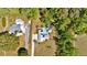 Aerial view of a home with pool, deck, and mature trees for a private backyard oasis at 245 Country Circle E Dr, Port Orange, FL 32128