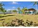 Large backyard featuring mature trees, a playset and a covered patio for outdoor entertaining or play at 245 Country Circle E Dr, Port Orange, FL 32128