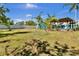 A sprawling backyard featuring a playground and pergola with dining area, perfect for outdoor enjoyment at 245 Country Circle E Dr, Port Orange, FL 32128