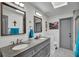 Bathroom with double sinks, granite countertops, tile floors and a separate toilet room at 245 Country Circle E Dr, Port Orange, FL 32128
