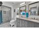 A remodeled bathroom features tile floors, a walk-in shower, and a double vanity with granite countertop at 245 Country Circle E Dr, Port Orange, FL 32128