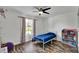 Comfortable bedroom showcasing wood-look floors, a ceiling fan, and a bright window at 245 Country Circle E Dr, Port Orange, FL 32128