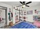 Stylish bedroom with a ceiling fan, mirrored closet doors, and a built-in desk area at 245 Country Circle E Dr, Port Orange, FL 32128