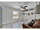 Versatile room featuring tile floors, a ceiling fan, and a bright window overlooking the backyard at 245 Country Circle E Dr, Port Orange, FL 32128