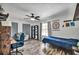 Bedroom featuring modern laminate flooring, a ceiling fan, and desk space at 245 Country Circle E Dr, Port Orange, FL 32128