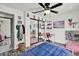 Bedroom with a large mirrored closet, wood-look floors, and a cozy pink beanbag chair at 245 Country Circle E Dr, Port Orange, FL 32128