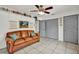 The bedroom area offers tile flooring, a ceiling fan, and cozy couch for relaxing at 245 Country Circle E Dr, Port Orange, FL 32128