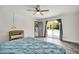 Bright bedroom featuring a ceiling fan, sliding glass doors to the pool, and wood-look flooring at 245 Country Circle E Dr, Port Orange, FL 32128