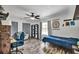 Spacious bedroom with wood-look floors, a ceiling fan, and a cozy seating area at 245 Country Circle E Dr, Port Orange, FL 32128