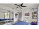 Bright bedroom with a ceiling fan, mirrored closet doors, and playful decor at 245 Country Circle E Dr, Port Orange, FL 32128