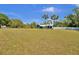 Expansive lawn surrounds this home, enhanced by palm trees and a pristine white fence at 245 Country Circle E Dr, Port Orange, FL 32128