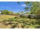 Exterior view showing a well-maintained property with a black fence and lush landscaping at 245 Country Circle E Dr, Port Orange, FL 32128