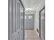 Hallway features tiled floors, painted doors, a closet, and modern lighting at 245 Country Circle E Dr, Port Orange, FL 32128