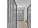 Well-lit hallway with neutral-colored tile flooring and closet space at 245 Country Circle E Dr, Port Orange, FL 32128
