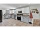 Modern kitchen featuring stainless steel appliances, two-tone cabinets, and granite countertops at 245 Country Circle E Dr, Port Orange, FL 32128