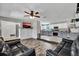 Open living area connecting the living room and kitchen, featuring hardwood floors and ceiling fan at 245 Country Circle E Dr, Port Orange, FL 32128