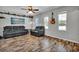 Spacious living room with two black leather couches, decorative shelves and lots of natural light at 245 Country Circle E Dr, Port Orange, FL 32128