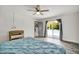 A cozy main bedroom features hardwood floors, ceiling fan, and sliding door to the pool area at 245 Country Circle E Dr, Port Orange, FL 32128