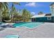 Relaxing backyard with pool, patio, teal outdoor chairs, and hammock at 245 Country Circle E Dr, Port Orange, FL 32128