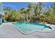 Backyard pool and deck with outdoor lounge chairs, hammock, and covered patio at 245 Country Circle E Dr, Port Orange, FL 32128