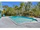 Inviting backyard pool with comfortable lounging chairs, landscaping, and dining area is perfect for relaxing at 245 Country Circle E Dr, Port Orange, FL 32128