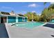 Sparkling pool with backyard views, a turquoise house with a metal roof, and a patio at 245 Country Circle E Dr, Port Orange, FL 32128