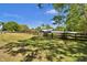 Scenic view of a rural property with a fenced yard and lush green grass at 245 Country Circle E Dr, Port Orange, FL 32128