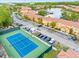 Aerial view of the tennis court and the community with lake views at 2608 Roadster Ln, Kissimmee, FL 34746